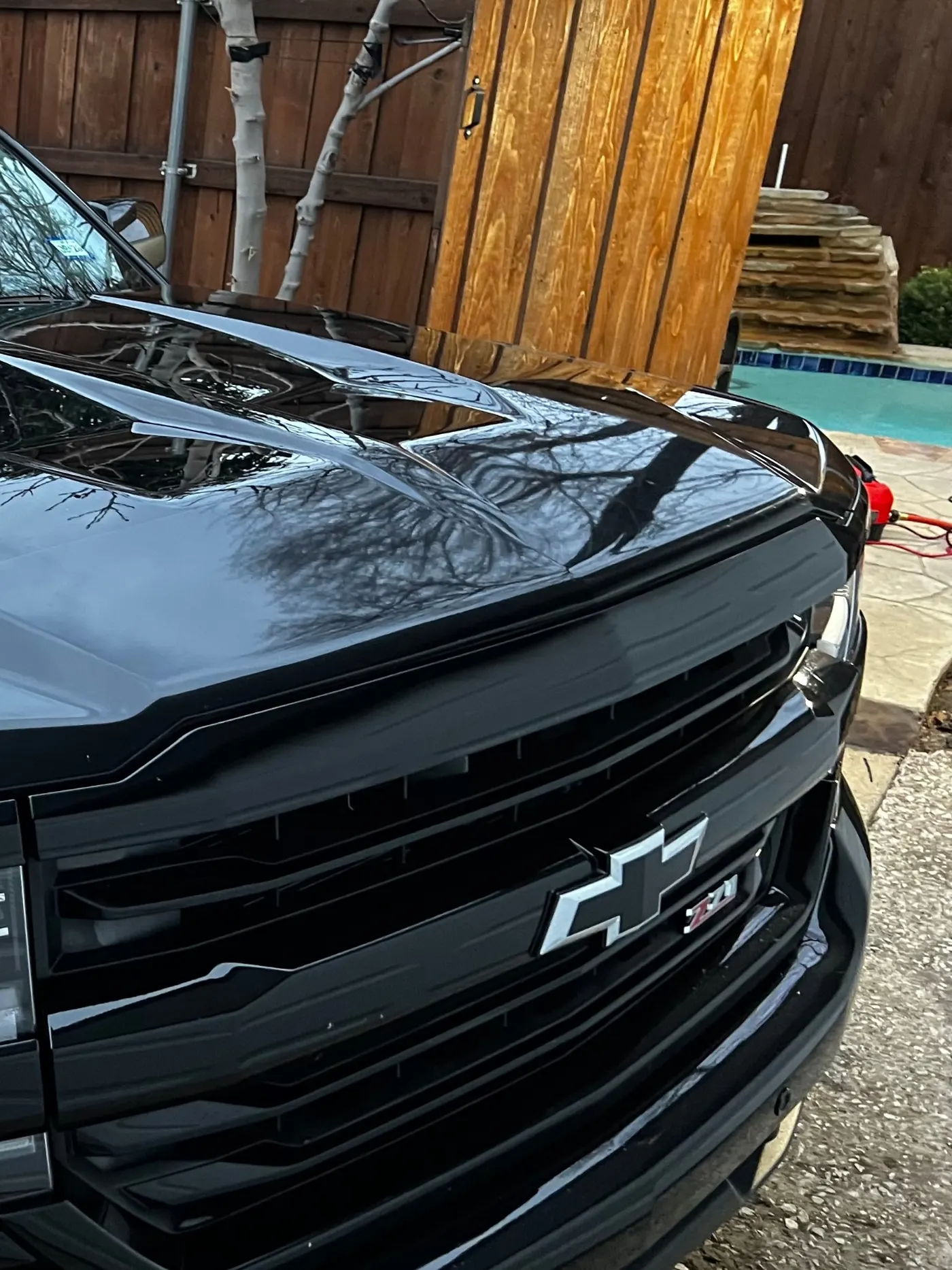 Chevy Silverado black grille and hood reflection close-up