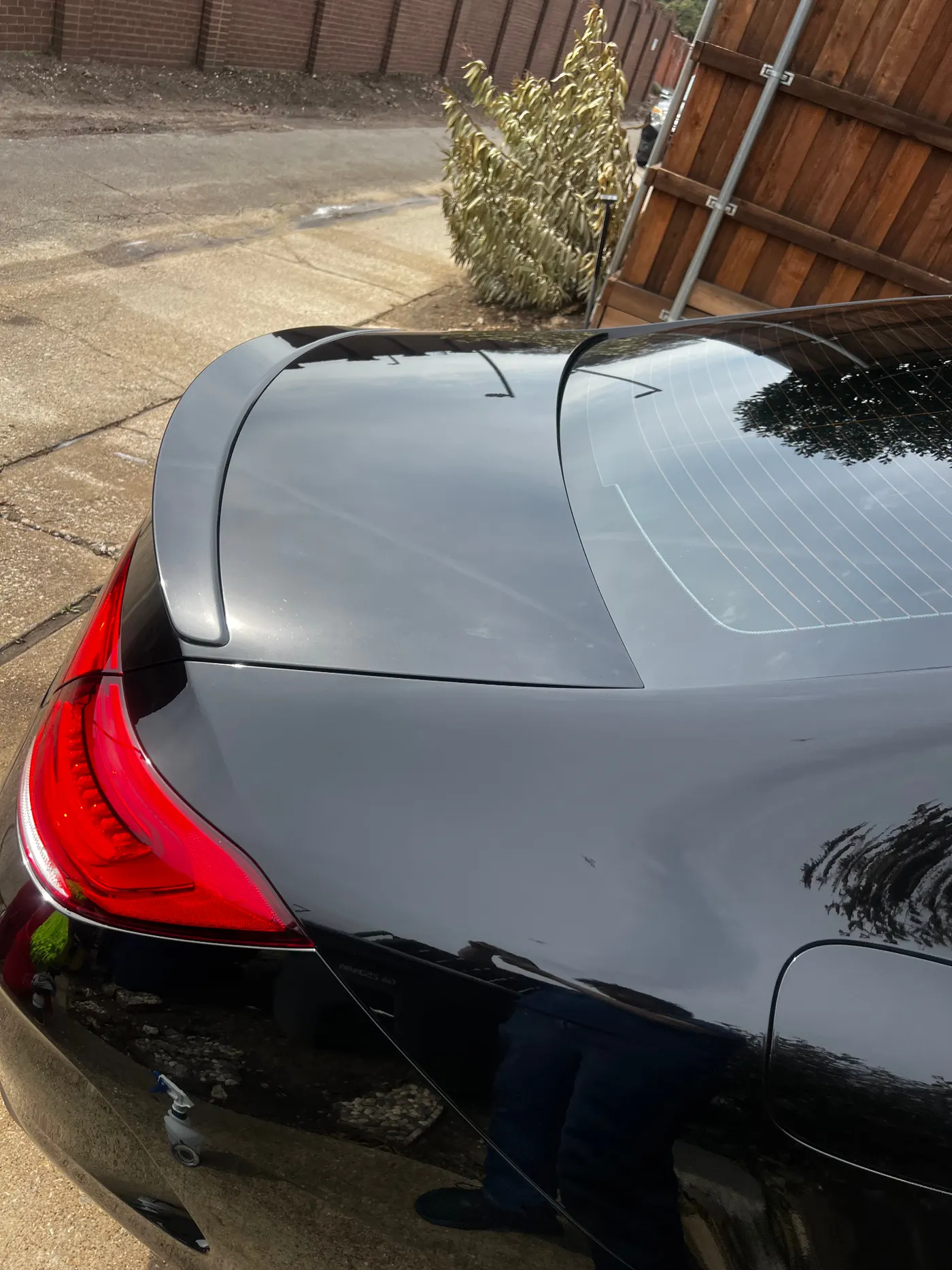 Blacked-out coupe rear deck and spoiler with flawless reflection